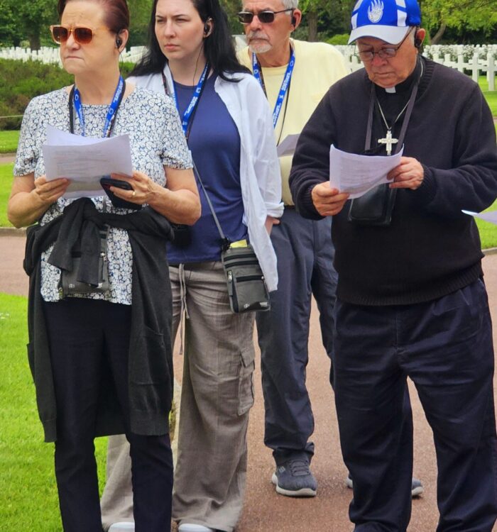 Fr. Clay prays for the soldiers-Normandy Cemetery